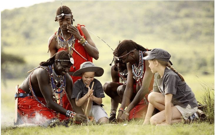 two_white_boys-visiting_a_maasai_village